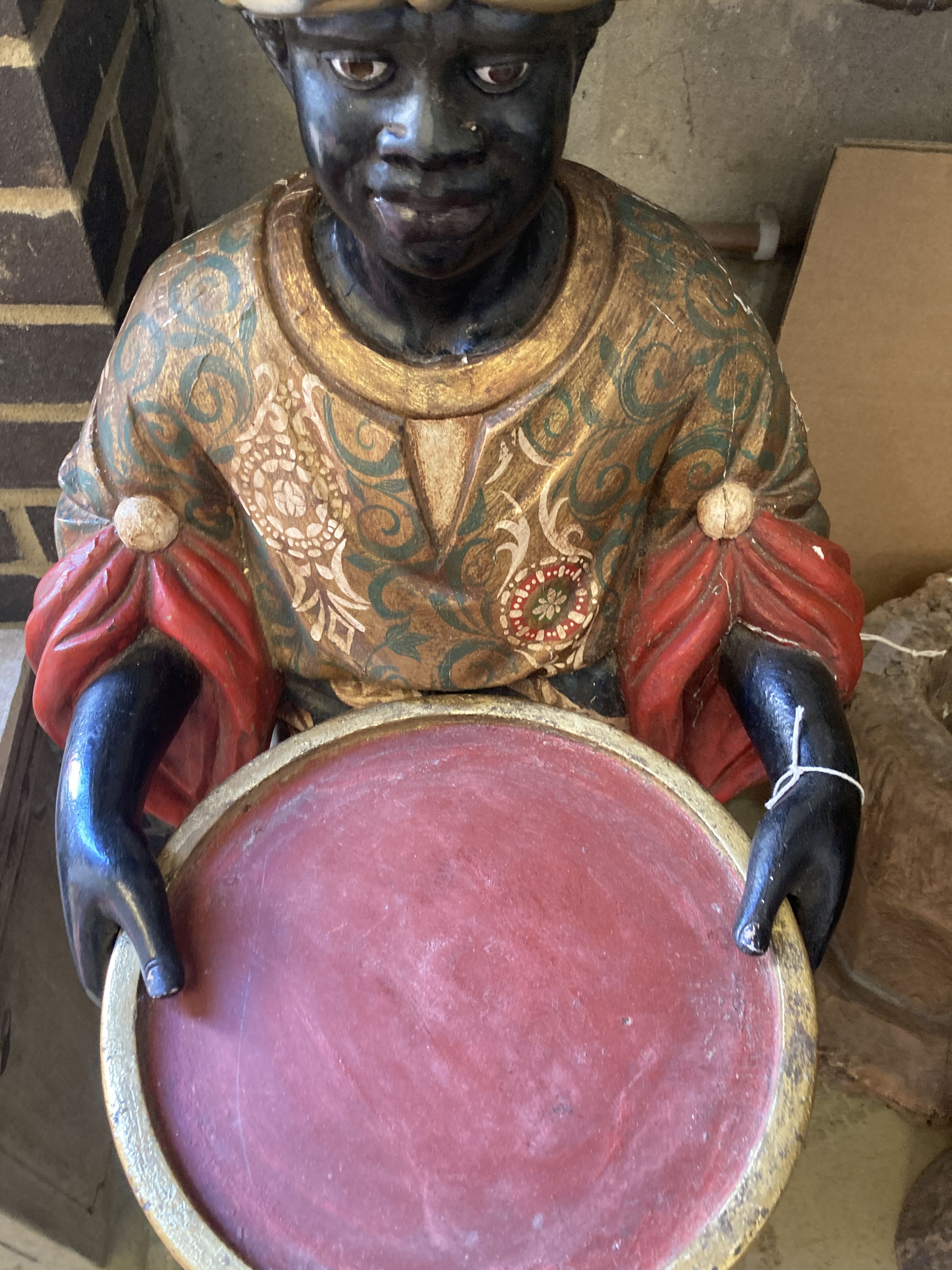 A carved, painted and gilded wood figural dumb waiter,